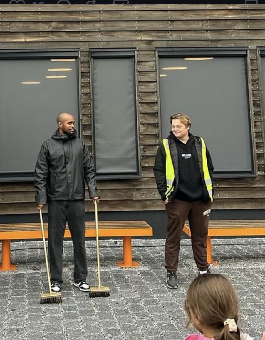 en gruppe mennesker som står utenfor en bygning en gruppe mennesker som står utenfor en bygning